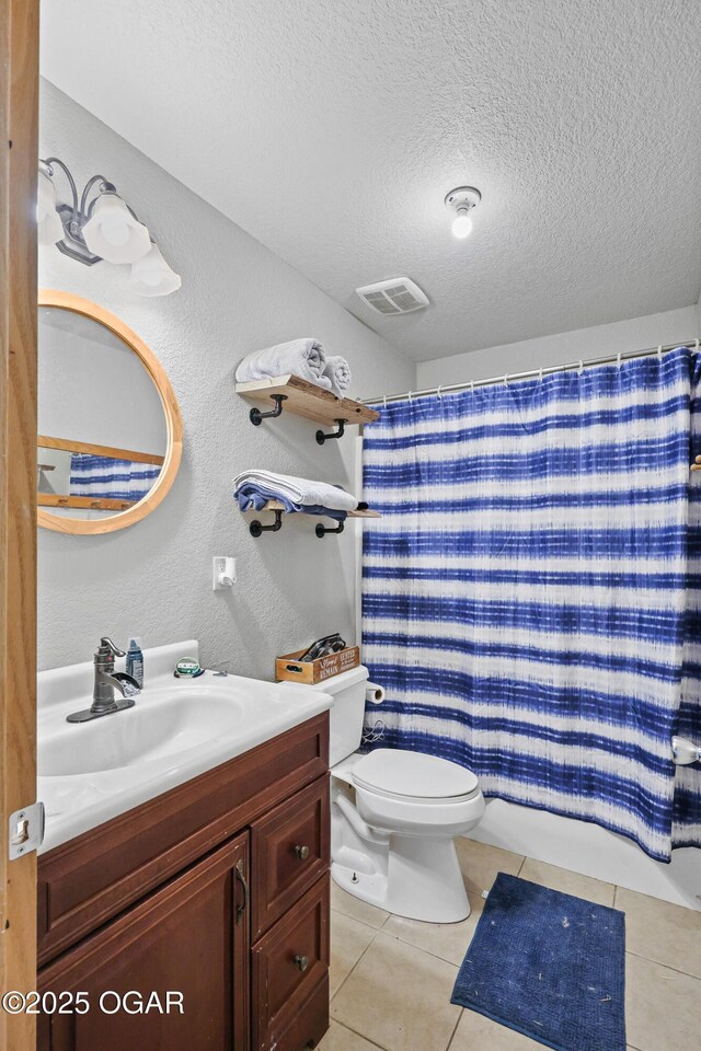 bathroom featuring tile patterned floors, visible vents, toilet, a textured ceiling, and vanity