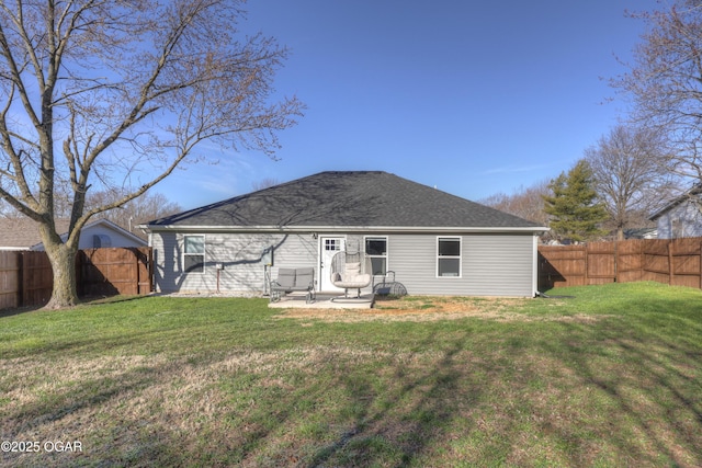 rear view of property with a patio, a yard, and a fenced backyard