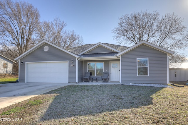 ranch-style house featuring a shingled roof, a front lawn, concrete driveway, covered porch, and a garage