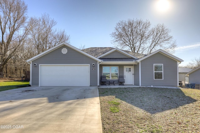 single story home featuring a garage, a front yard, driveway, and a shingled roof