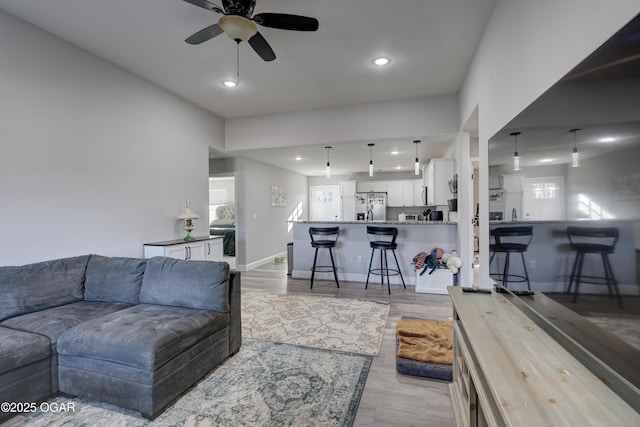 living room with recessed lighting, baseboards, wood finished floors, and a ceiling fan