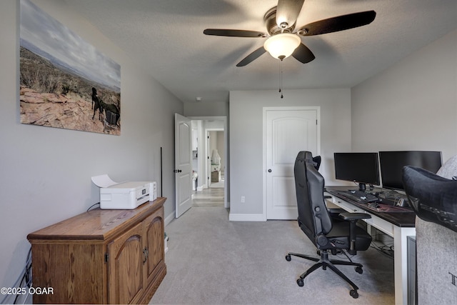 home office featuring baseboards, a ceiling fan, carpet flooring, and a textured ceiling