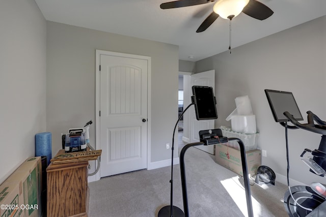 exercise room featuring carpet, baseboards, and ceiling fan