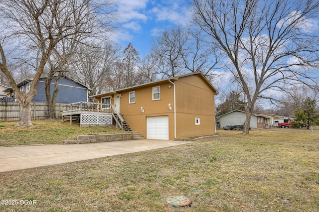 view of side of property with driveway, stairway, an attached garage, and a lawn