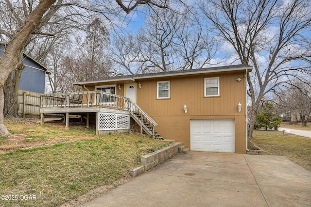 view of front of house featuring concrete driveway, a wooden deck, an attached garage, and stairs