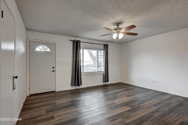 entrance foyer with a textured ceiling, baseboards, dark wood finished floors, and a ceiling fan