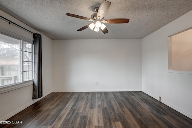 spare room featuring a ceiling fan, dark wood-style flooring, a textured ceiling, and baseboards