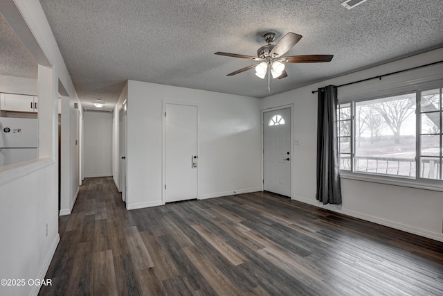 foyer entrance featuring dark wood-style floors, ceiling fan, a textured ceiling, and baseboards