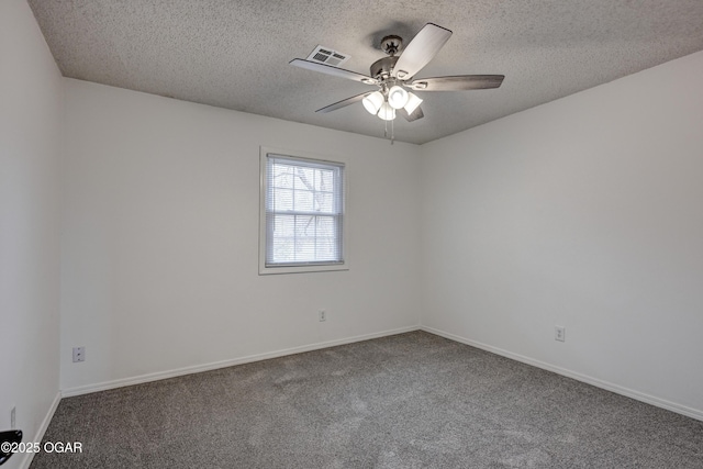 carpeted spare room with visible vents, ceiling fan, a textured ceiling, and baseboards