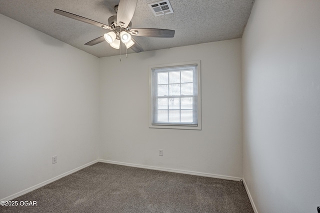 carpeted spare room with a textured ceiling, a ceiling fan, visible vents, and baseboards