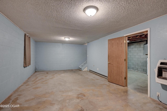 finished basement with heating unit, stairs, a baseboard heating unit, and concrete block wall