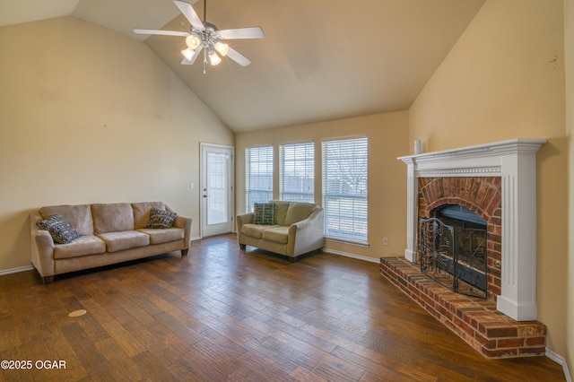 living area with a brick fireplace, baseboards, and wood finished floors