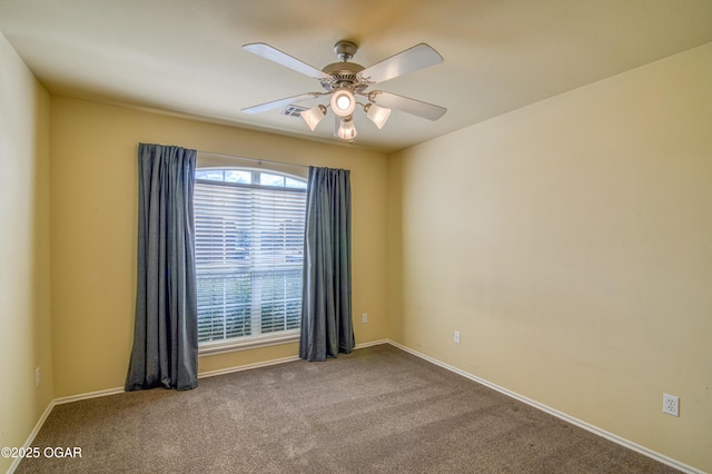 unfurnished room featuring ceiling fan, carpet flooring, and baseboards