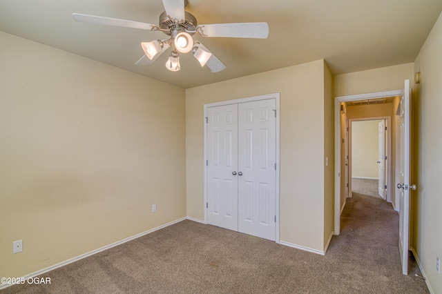 unfurnished bedroom with carpet floors, a closet, a ceiling fan, and baseboards