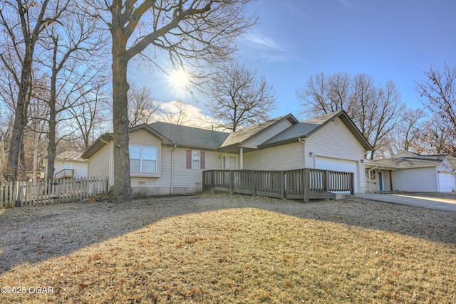 exterior space with a garage, driveway, and fence