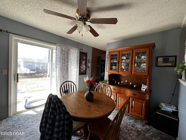 dining room with a textured ceiling and carpet floors