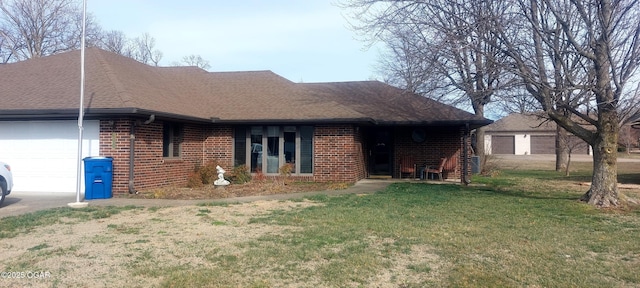 ranch-style home with brick siding, a front lawn, an attached garage, and a shingled roof