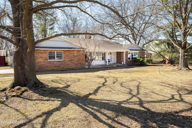 single story home with covered porch and brick siding