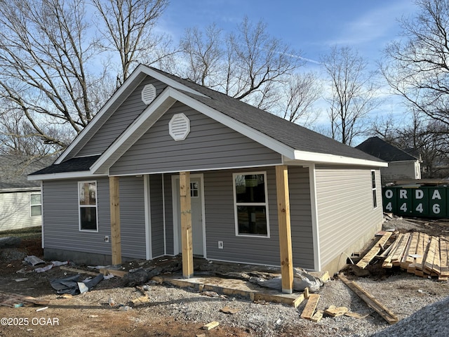 view of front of house with covered porch and roof with shingles