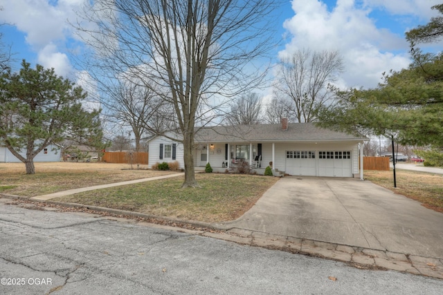 single story home with a garage, fence, concrete driveway, and a front yard