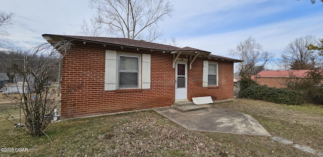 rear view of house with brick siding and entry steps