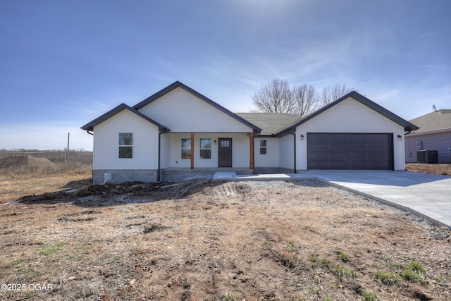 view of front of house with a garage, covered porch, driveway, and cooling unit