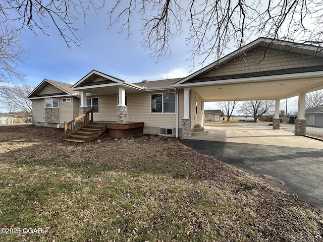 view of front of property with driveway, covered porch, and a carport