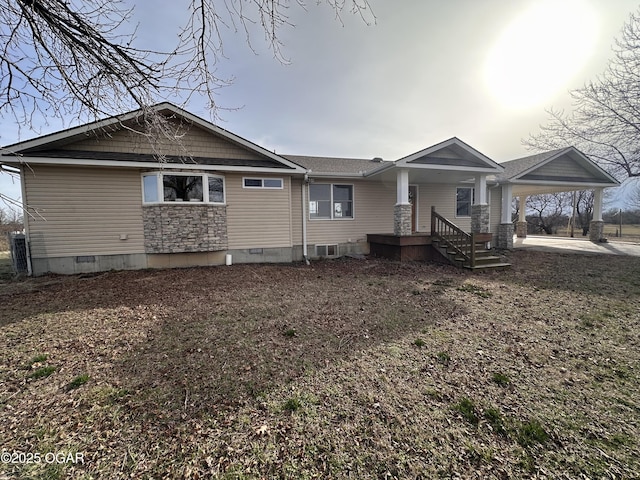 view of front facade with a carport and crawl space