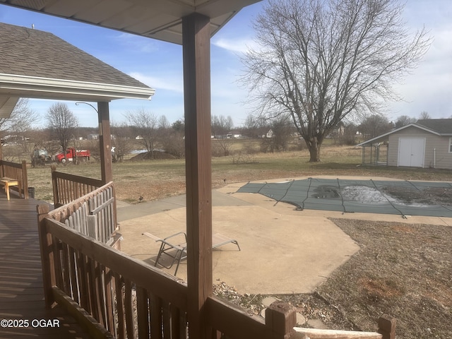 exterior space featuring a yard, a patio area, and an outdoor structure