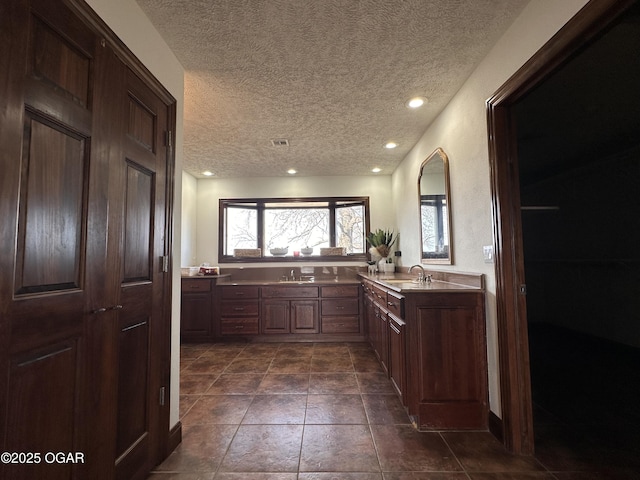 full bathroom with recessed lighting, visible vents, a textured ceiling, vanity, and a bath