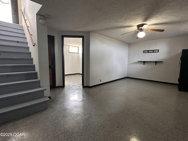 interior space with baseboards, ceiling fan, stairway, a textured ceiling, and speckled floor