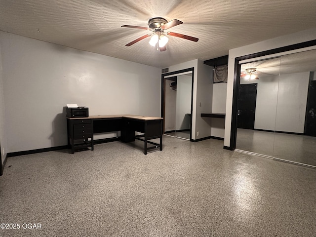 office area with visible vents, a ceiling fan, a textured ceiling, baseboards, and speckled floor