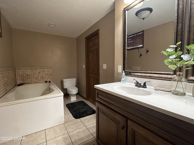 full bath with tile patterned floors, toilet, a textured ceiling, vanity, and a bath