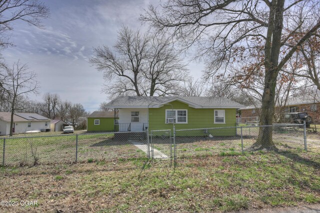117 E Russell St, Goodman, MO 64843 - view of front of property with a fenced front yard, a gate, and a shingled roof