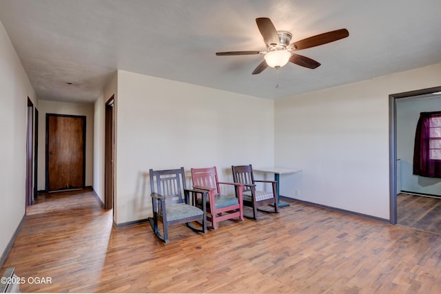 117 E Russell St, Goodman, MO 64843 - sitting room featuring a ceiling fan, baseboards, and wood finished floors