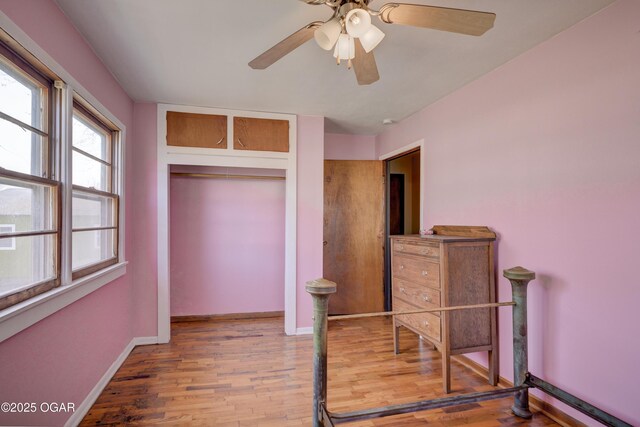 117 E Russell St, Goodman, MO 64843 - bedroom featuring a ceiling fan, a closet, baseboards, and wood finished floors