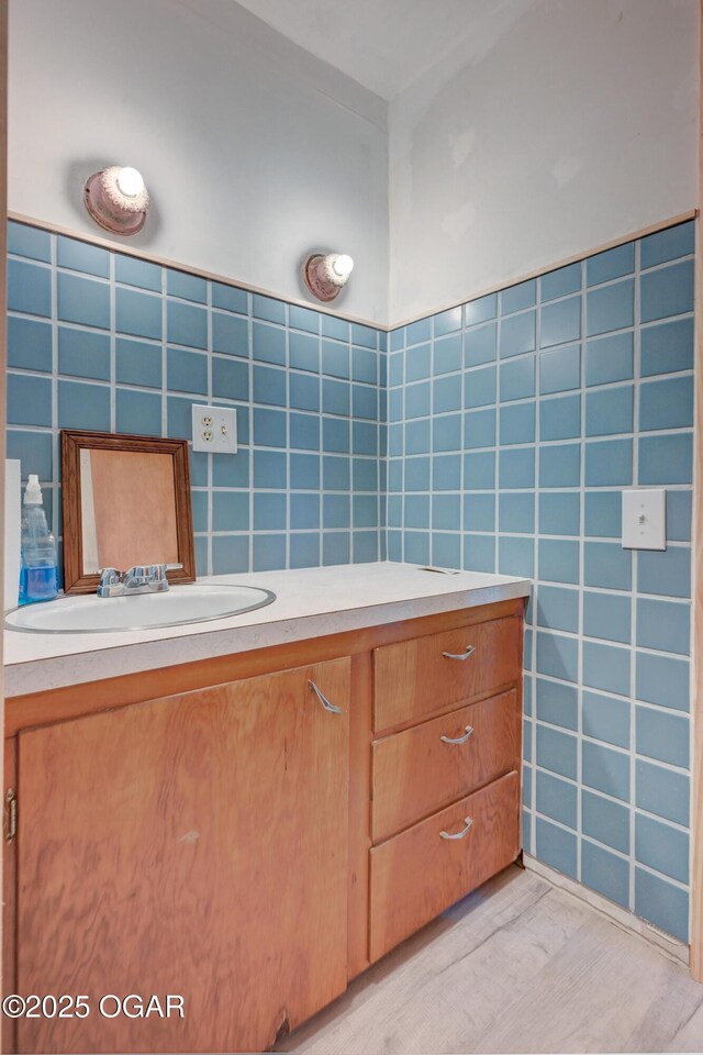 117 E Russell St, Goodman, MO 64843 - bathroom with tile walls, vanity, and wood finished floors
