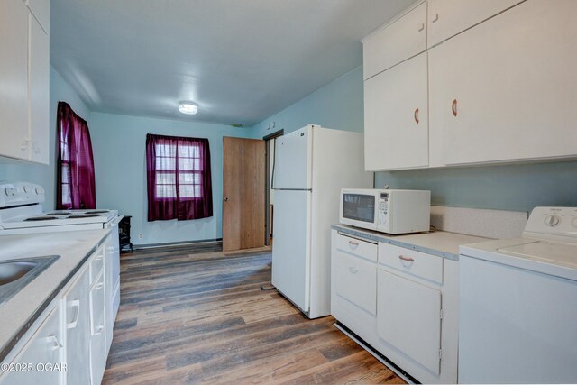 117 E Russell St, Goodman, MO 64843 - kitchen with washer / clothes dryer, light countertops, white cabinetry, wood finished floors, and white appliances