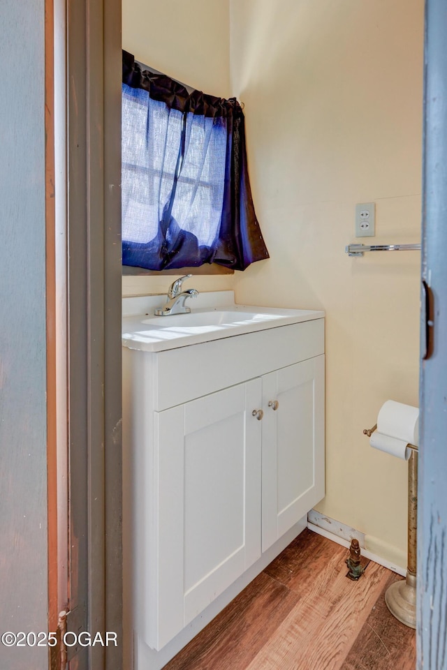 117 E Russell St, Goodman, MO 64843 - bathroom featuring wood finished floors and vanity