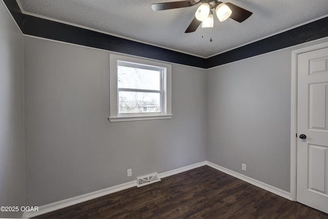 unfurnished room with dark wood-style floors, visible vents, a ceiling fan, a textured ceiling, and baseboards