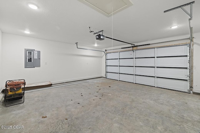 garage featuring electric panel, a garage door opener, and baseboards