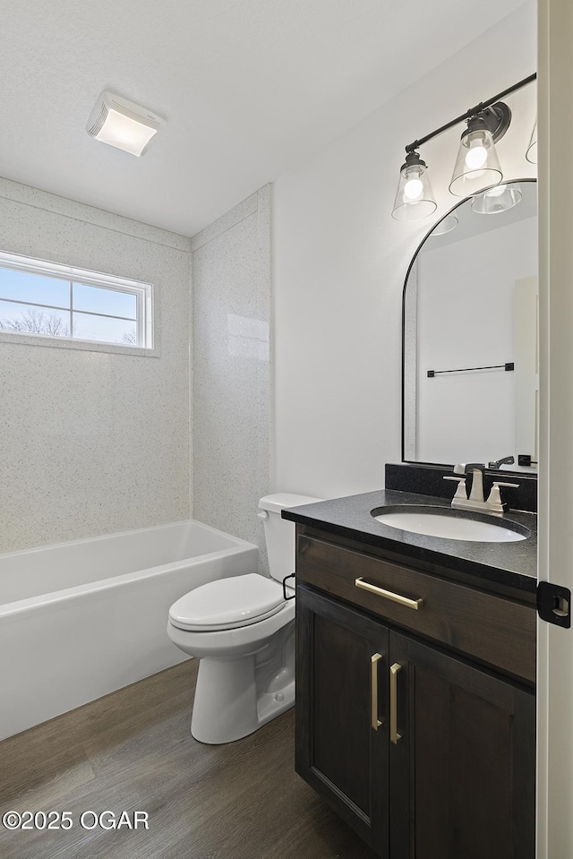 full bathroom featuring vanity, toilet, wood finished floors, and shower / bathtub combination