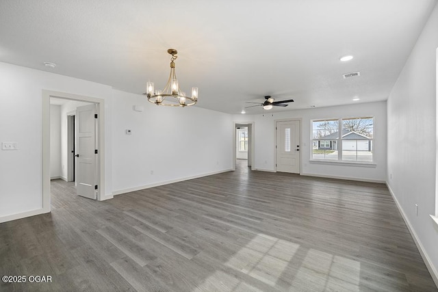 unfurnished living room with visible vents, baseboards, wood finished floors, and ceiling fan with notable chandelier