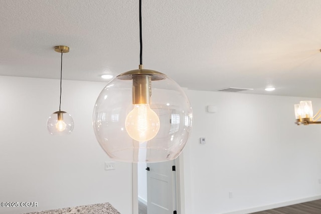 details featuring visible vents and a textured ceiling