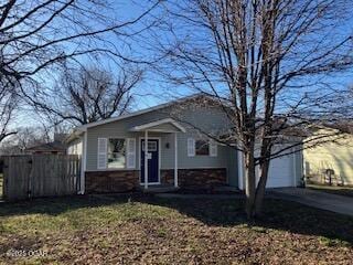 view of front of house with fence and driveway