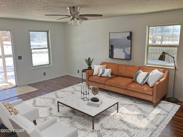 living room with a wealth of natural light, a textured ceiling, wood finished floors, and ceiling fan