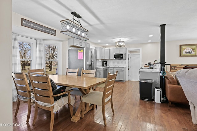 dining room featuring hardwood / wood-style floors and recessed lighting