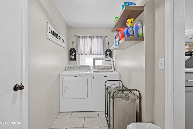 laundry room featuring laundry area, light tile patterned floors, and washing machine and dryer