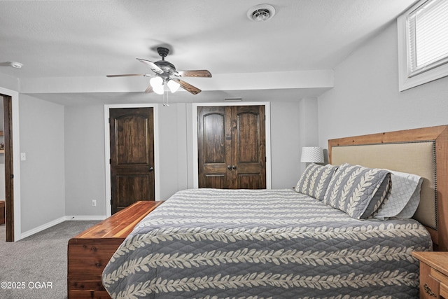 bedroom featuring visible vents, carpet floors, baseboards, and ceiling fan