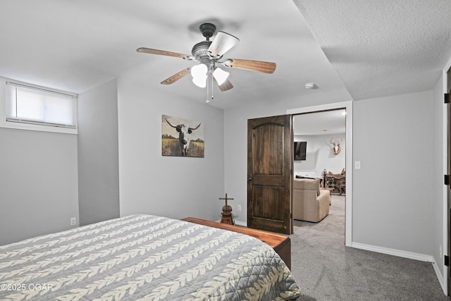 carpeted bedroom with baseboards, a textured ceiling, and ceiling fan